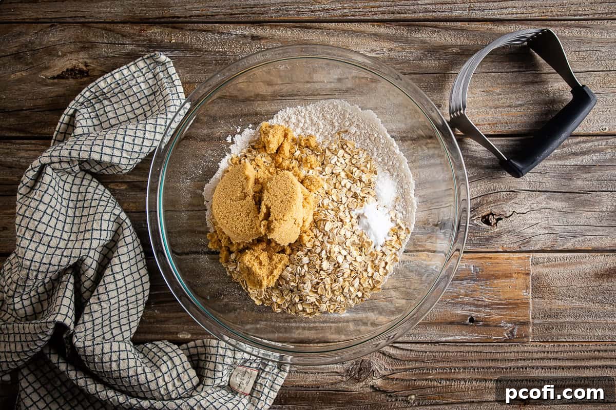 Dry ingredients for Oatmeal Carmelitas in a large glass bowl before being mixed.