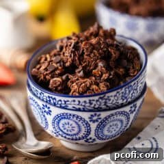 Close-up of baked chocolate granola with melted chocolate chips.