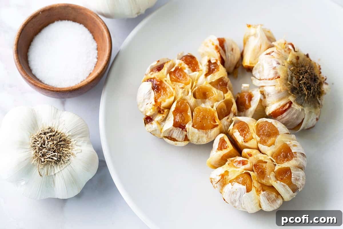 Beautifully roasted garlic cloves ready to be used, arranged artfully on a plate.