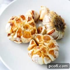 Three heads of roasted garlic, golden and tender.
