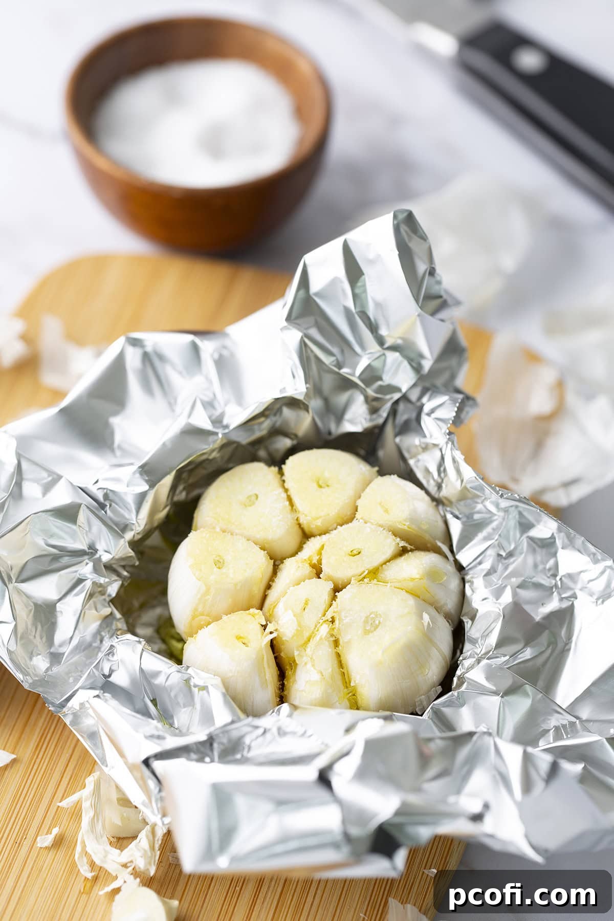 Kosher salt sprinkled on top of the olive oil-drizzled garlic.