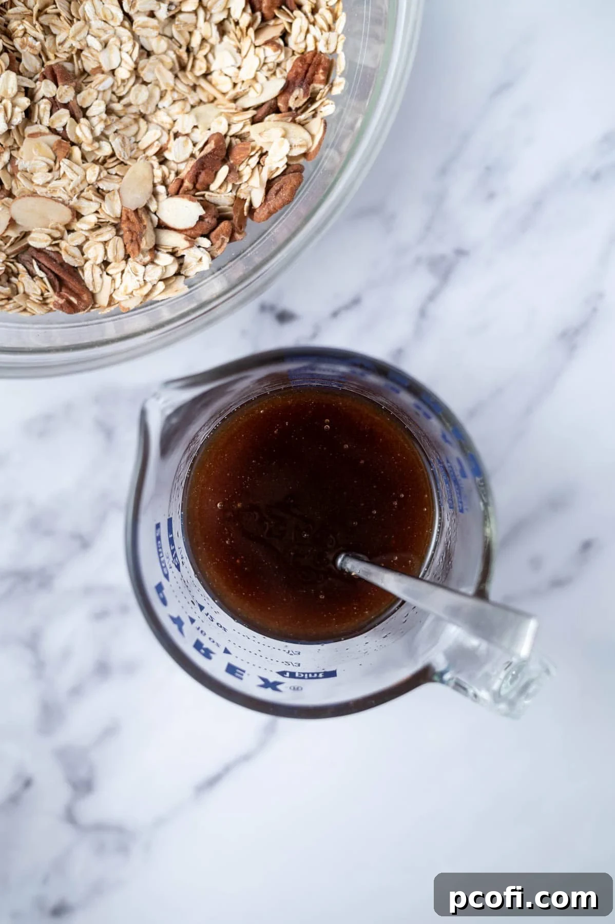 Wet ingredients: maple syrup, melted coconut oil, brown sugar, and vanilla extract mixed in a spouted measuring cup.