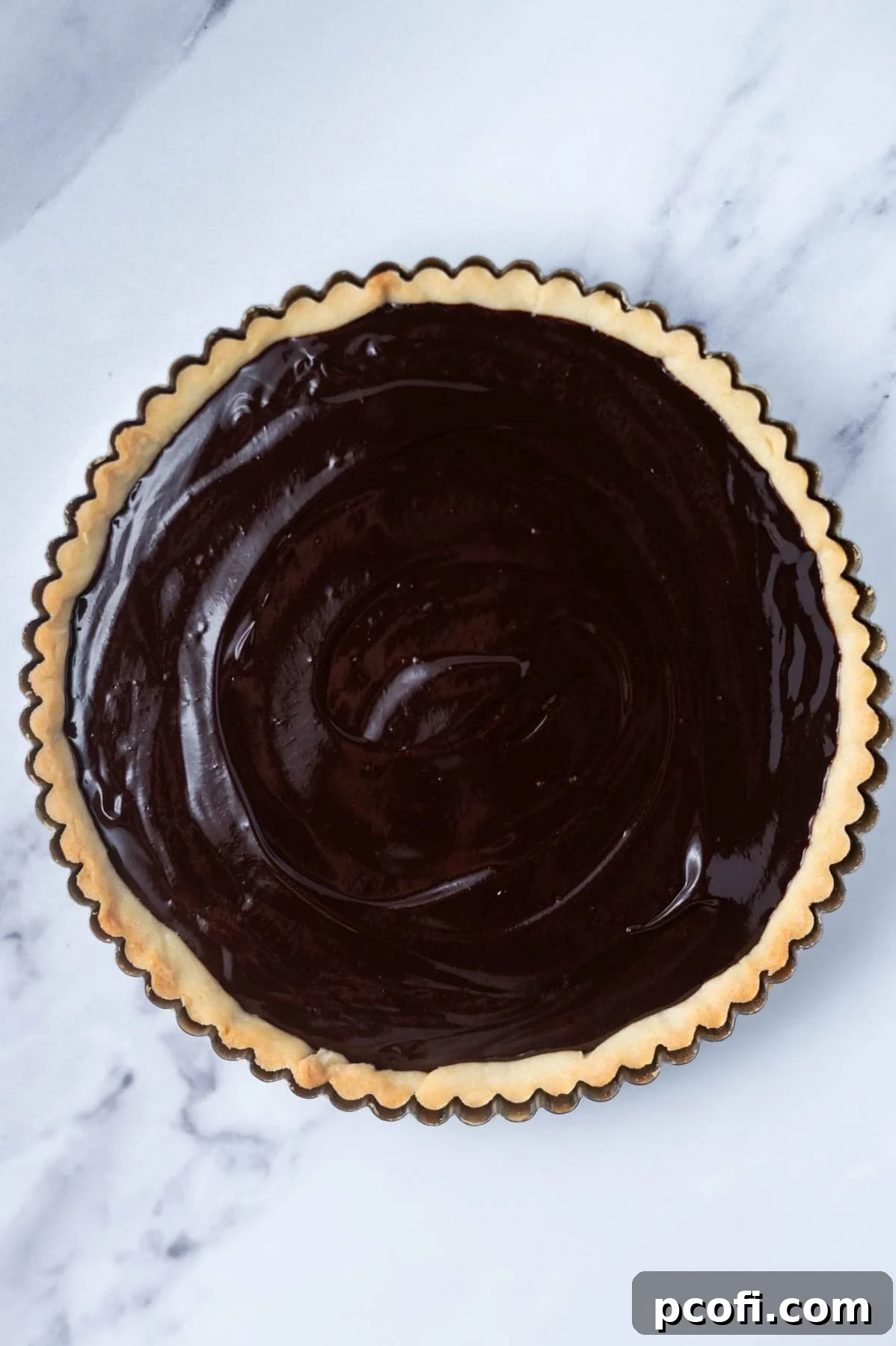 dark chocolate ganache filling in a baked tart shell