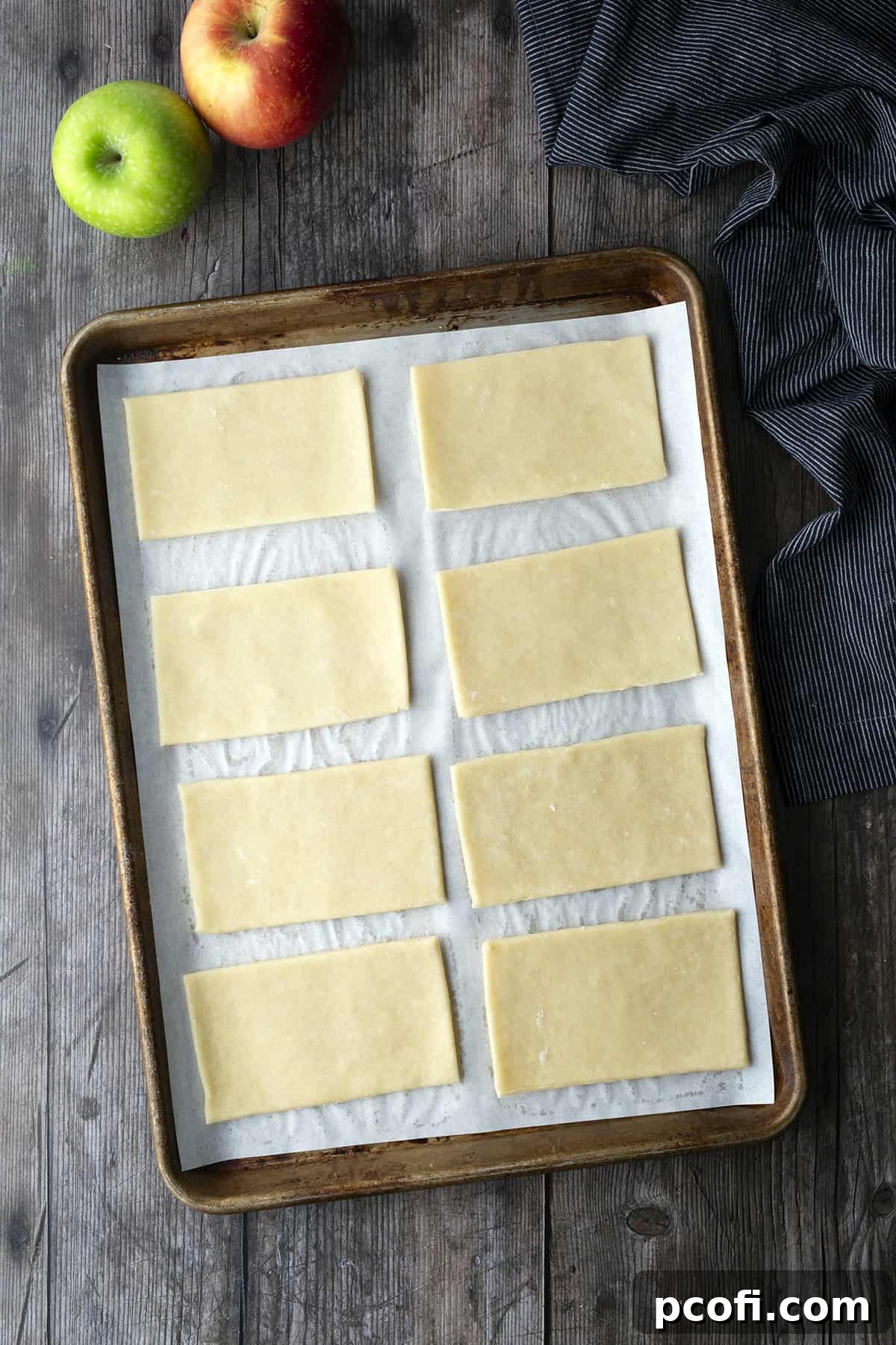 Pie dough cut into rectangular shapes on a baking mat
