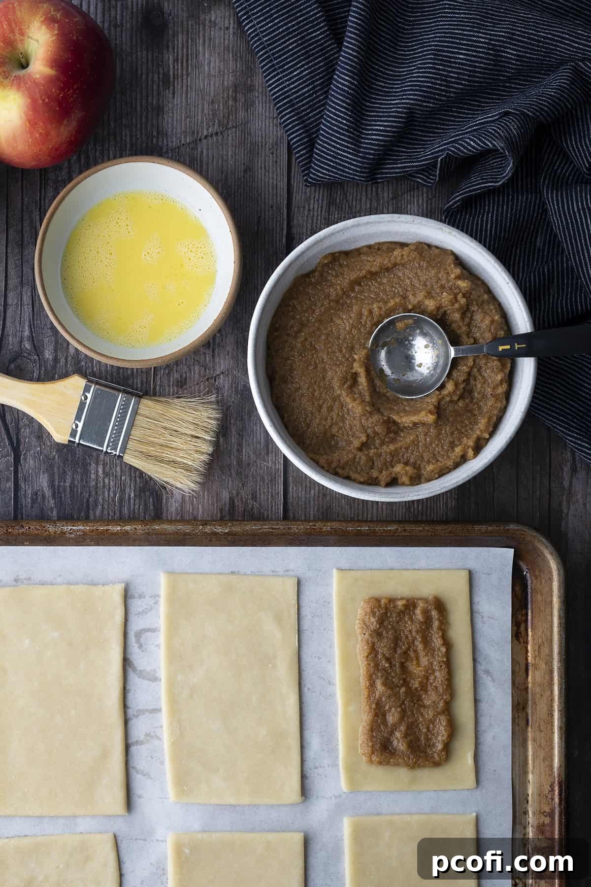 Apple puree filling spread on half of the dough rectangles