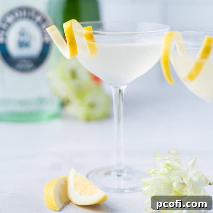 Elegant French 75 cocktail with a lemon twist, surrounded by bottles of gin and champagne, ready for a celebration.