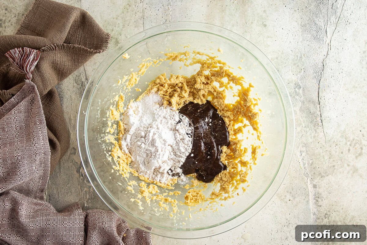Date puree and dry ingredients being stirred into the wet mixture for the sticky toffee pudding batter.