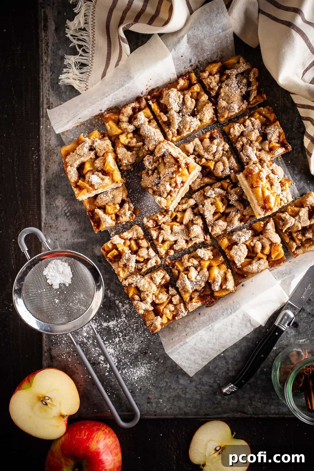 Delicious Apple Pie bars cut into neat squares and lightly dusted with powdered sugar, ready for serving.