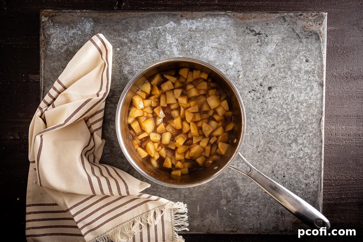 Perfectly cooked apple pie bar filling mixture, now syrupy and tender, after being gently simmered on the stovetop.