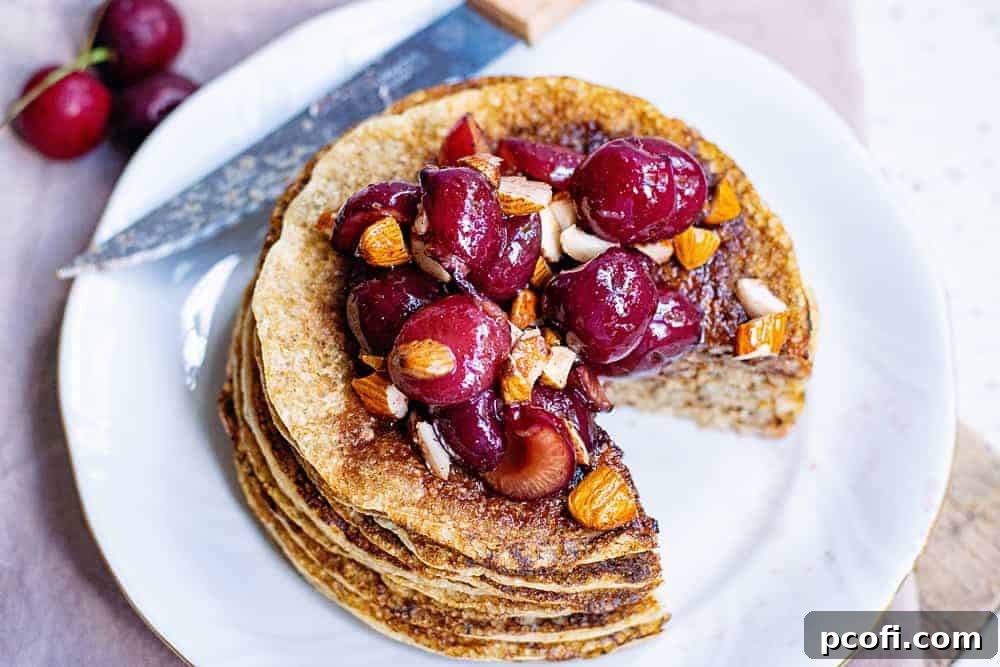 Fluffy Oatmeal Pancakes, a light and healthy breakfast option, stacked on a plate.