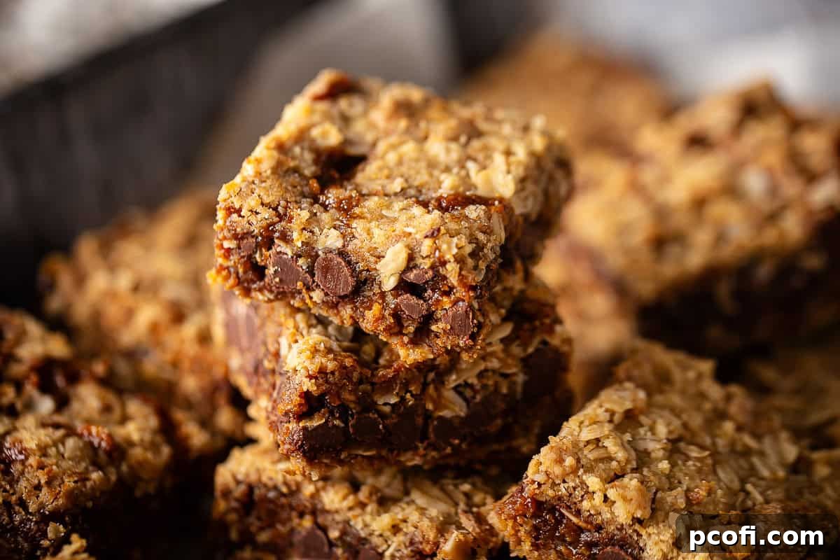 Classic Oatmeal Carmelitas, featuring layers of oats, brown sugar, chocolate chips, and caramel, cut into perfect squares.