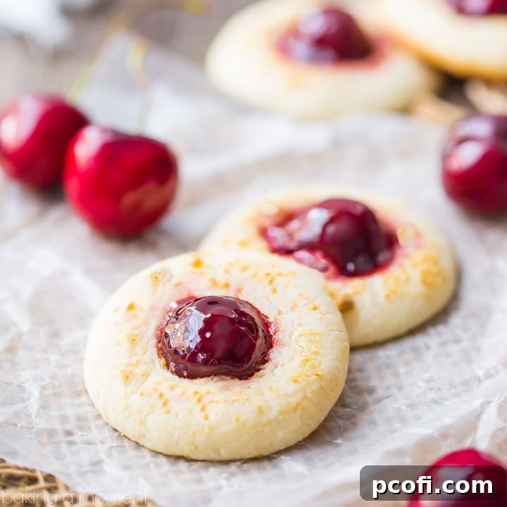 Delicious Cherry Cheesecake Thumbprint Cookies: the cream cheese cookie base perfectly complemented by glazed cherry and crunchy graham cracker crumbs.