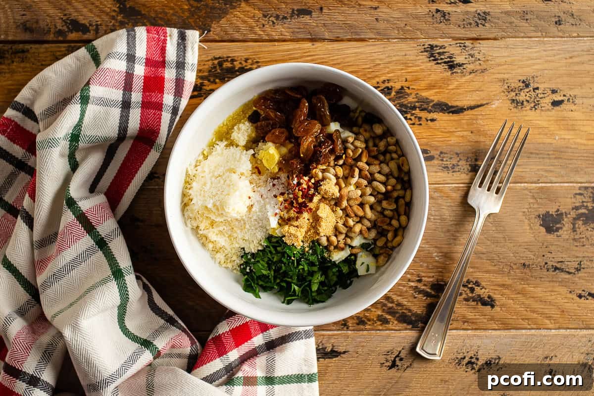 Bowl of unmixed Braciole filling ingredients: breadcrumbs, Parmesan, parsley, and pine nuts.
