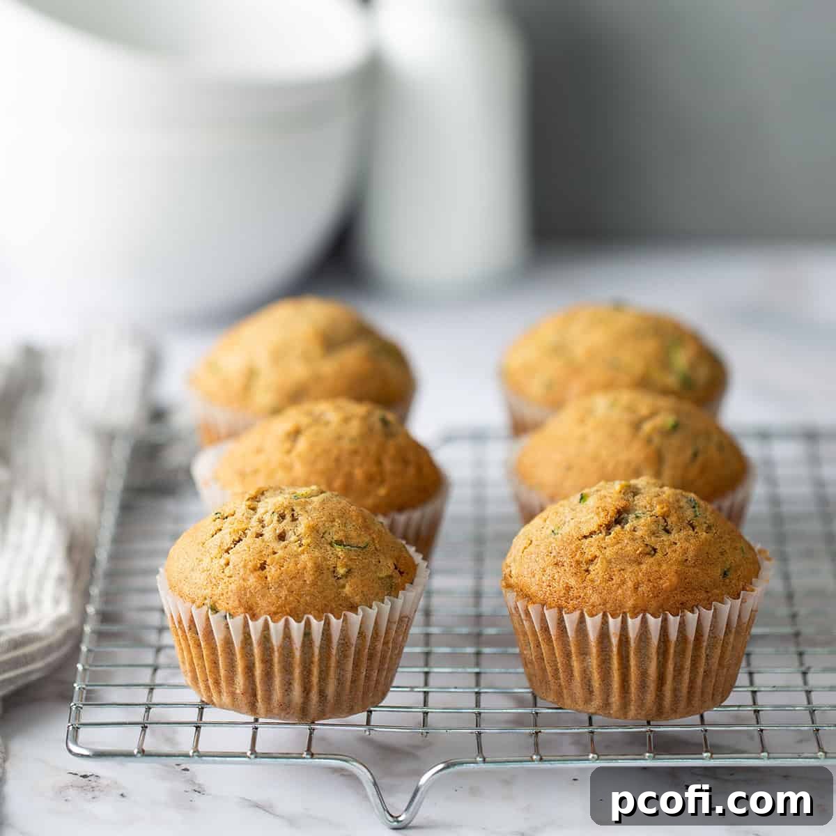 A closeup of moist and fluffy Zucchini Muffins, hinting at their delicious texture and subtle cinnamon flavor, ready for a quick snack or breakfast.