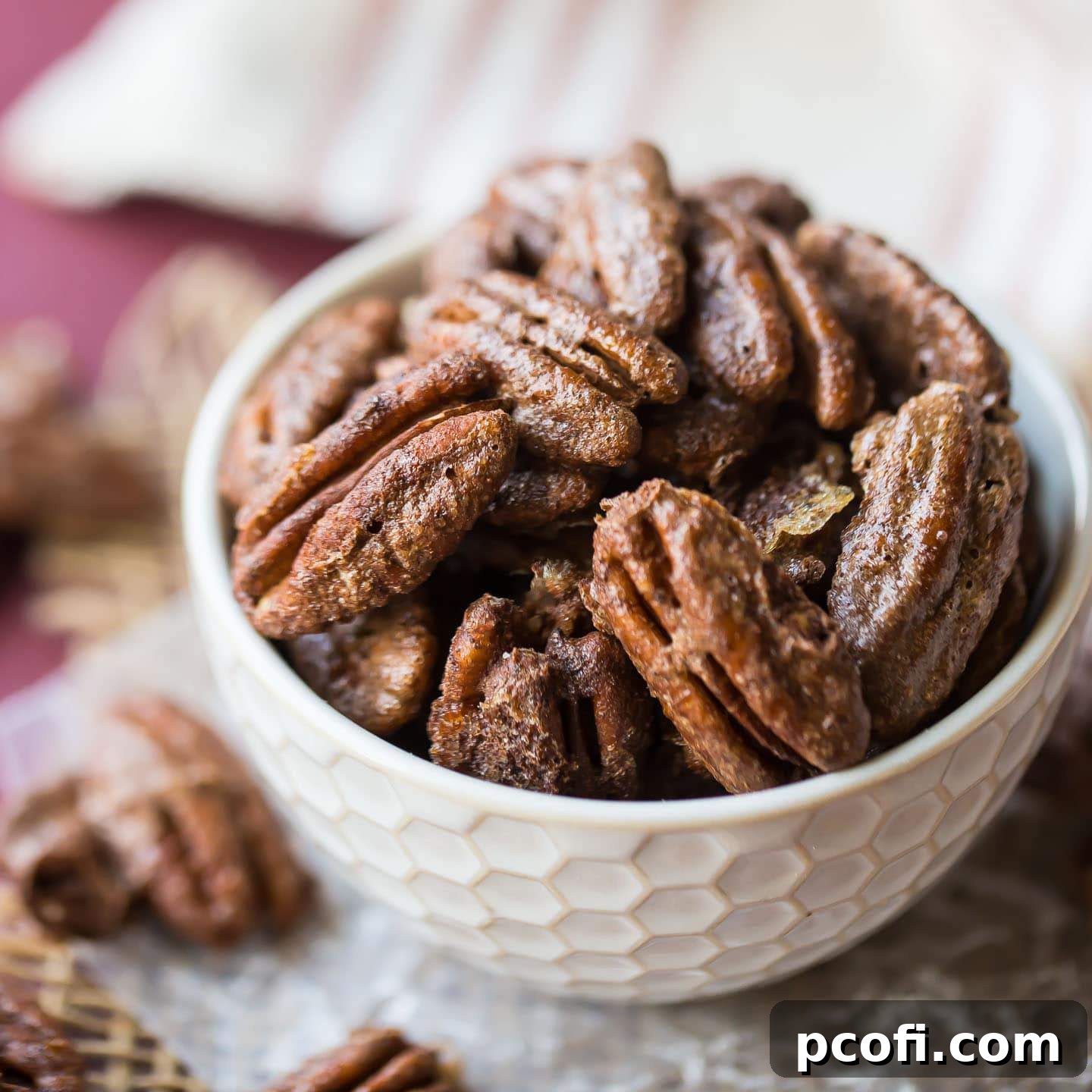A bowl of lightly coated, crunchy Cinnamon Pecans, perfectly sweet and ready for snacking or as a delicious addition to various dishes.