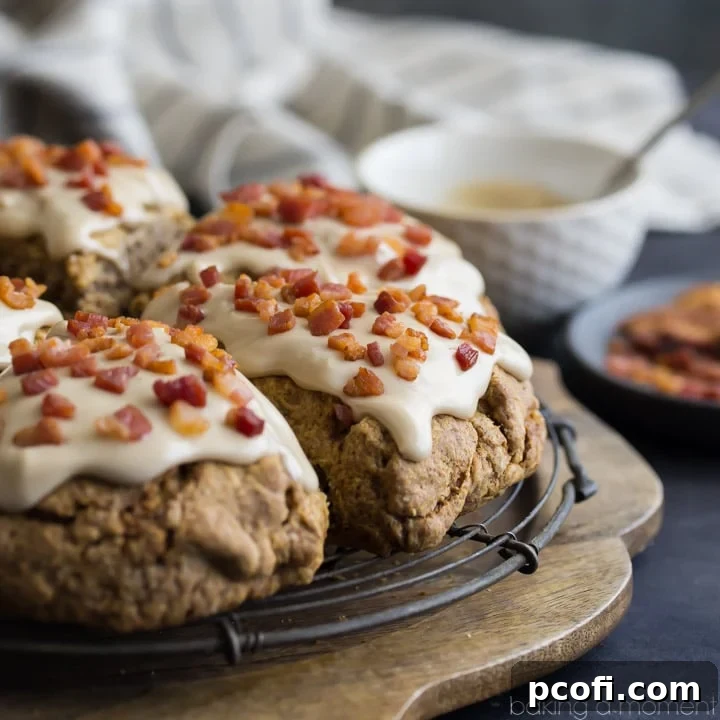 A close-up of Cinnamon Peanut Butter Chip Scones with Maple Bacon Glaze, showing their moist texture, visible peanut butter chips, and a luscious drizzle of glaze.