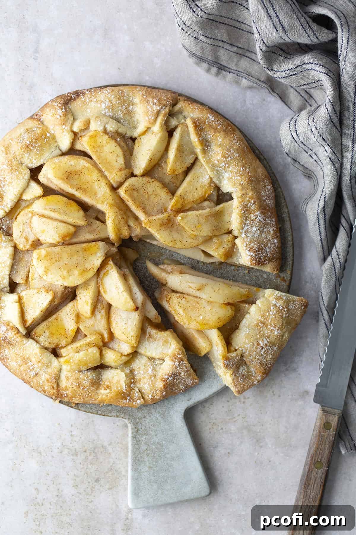 Pear crostata on a serving dish, showcasing its charmingly rustic appearance.