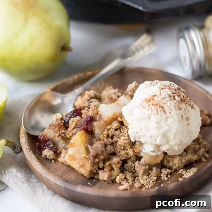 Pear cranberry crisp: a comforting cool-weather dessert with a buttery oatmeal pecan crumb.