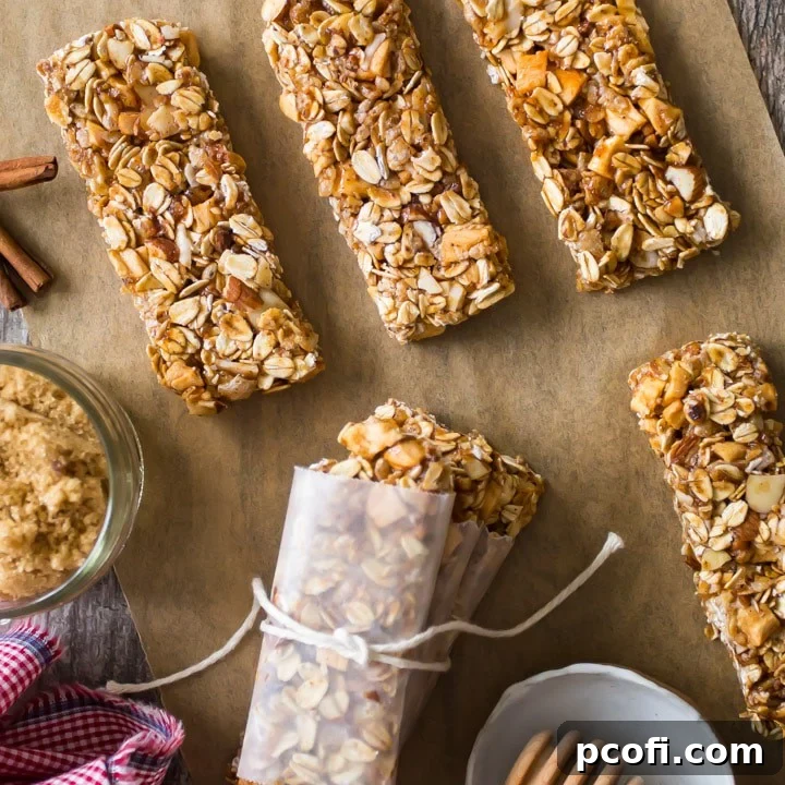 A stack of perfectly baked chewy granola bars, indicating a soft, satisfying texture, ideal for a portable snack.