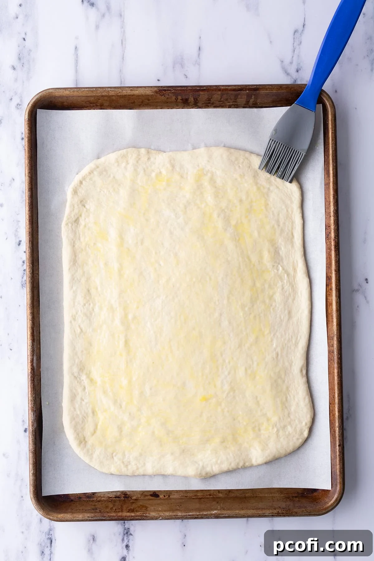 Egg wash being brushed onto the dough