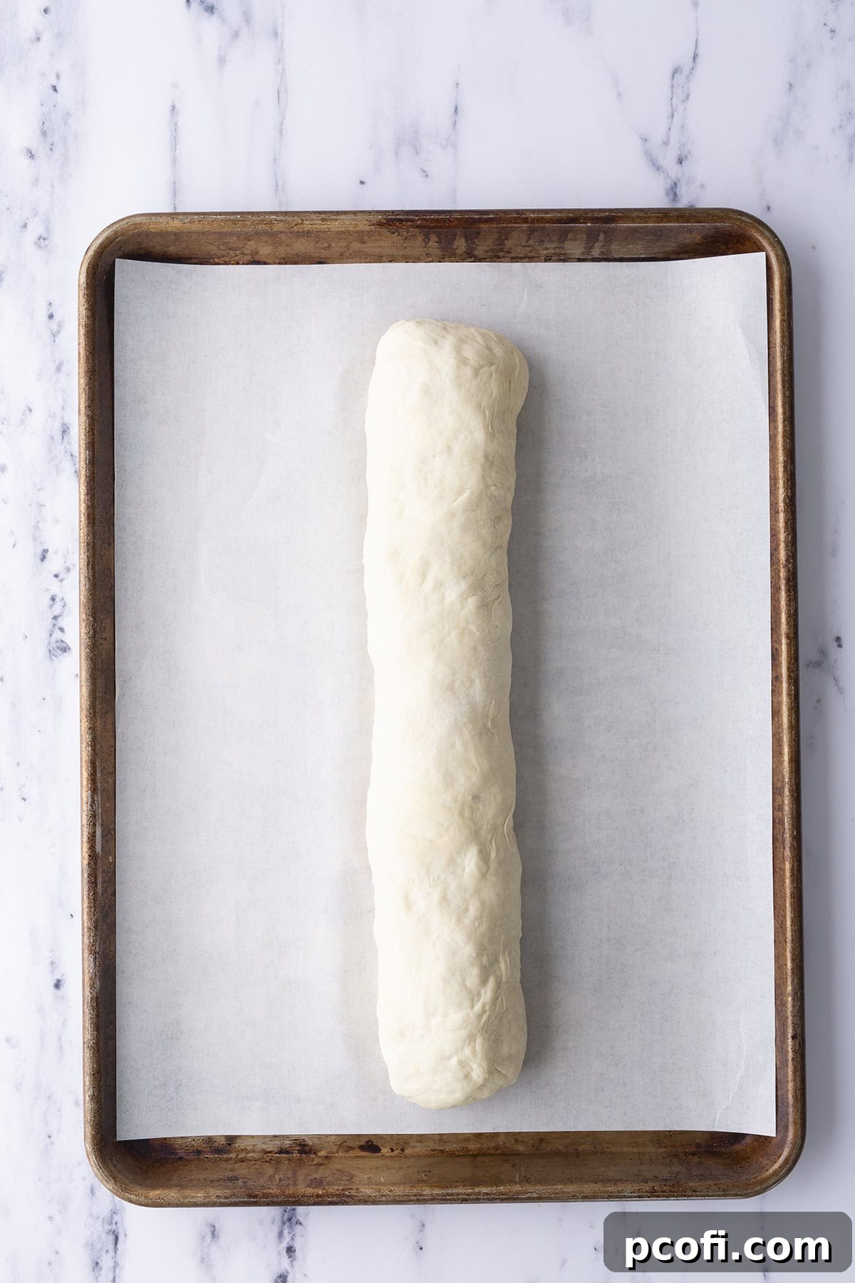 Pizza dough tightly rolled into a log with filling inside