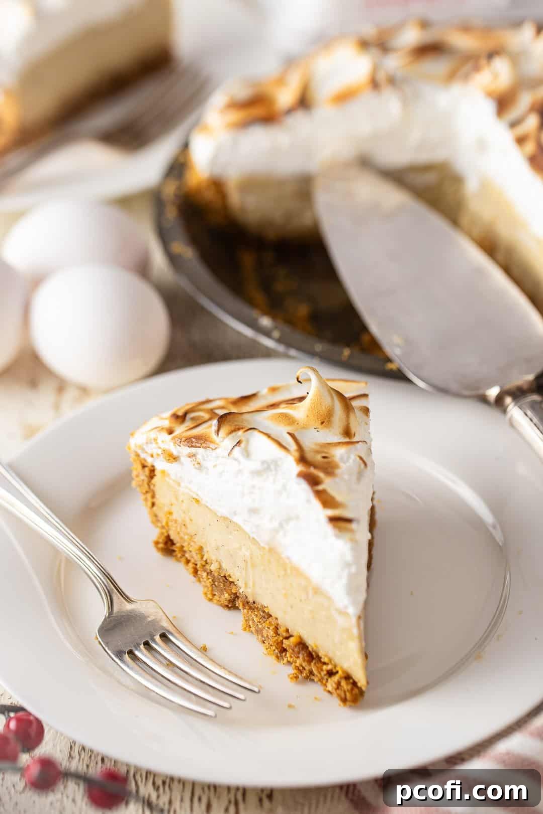 A beautifully presented homemade eggnog pie on a white plate, with a pie server ready to serve a slice.