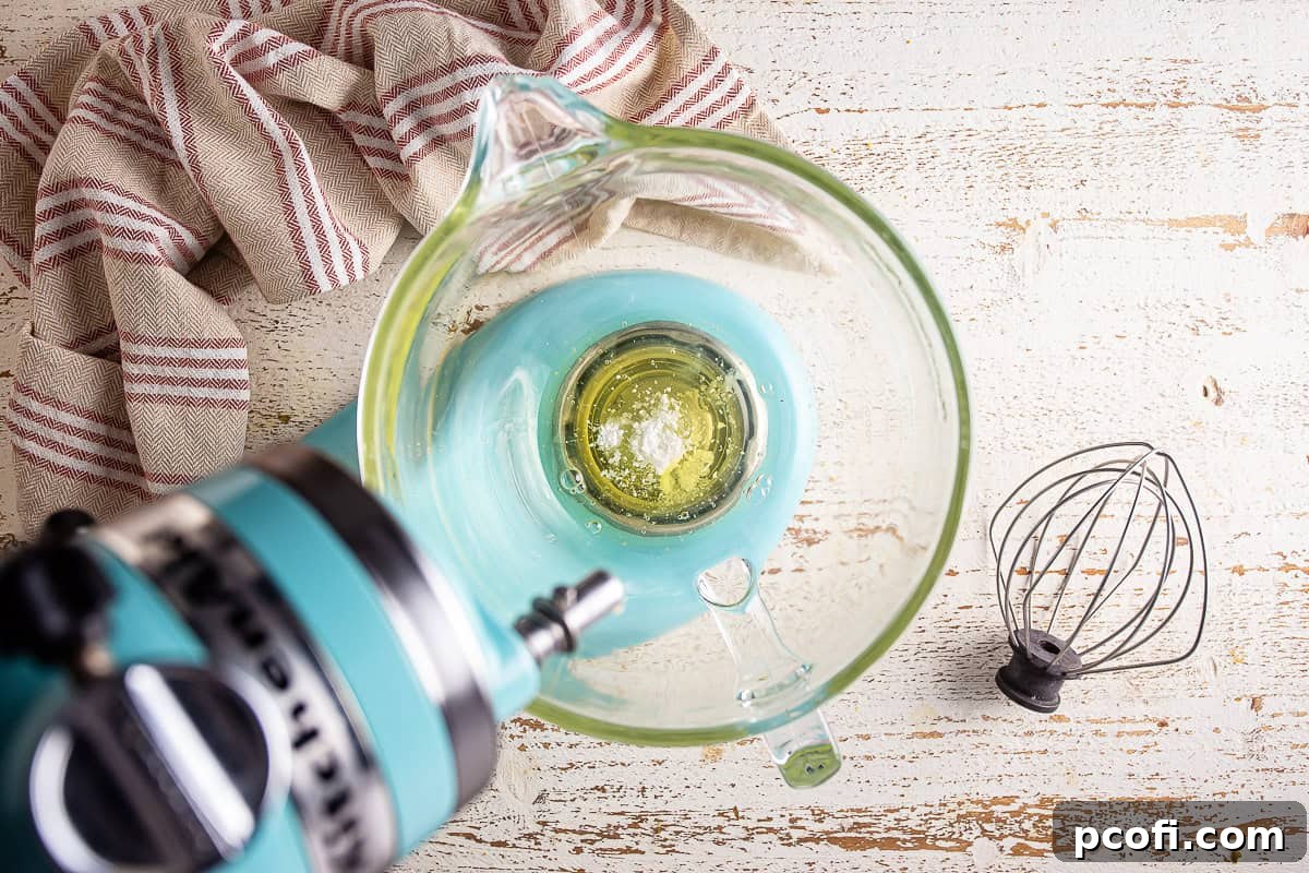 Egg whites, cream of tartar, and salt in a mixer bowl before being whipped into meringue.
