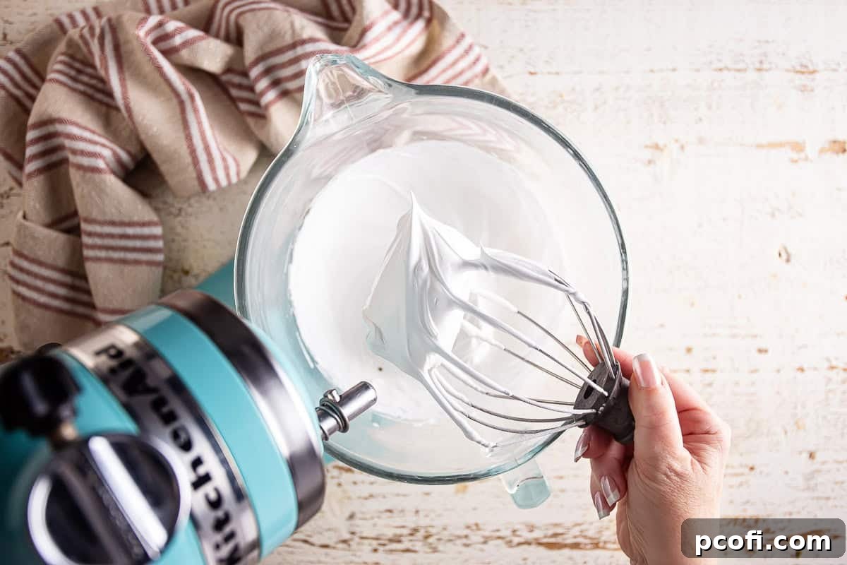 Finished, stiff, and glossy meringue in a mixing bowl, ready to be spread onto the pie.