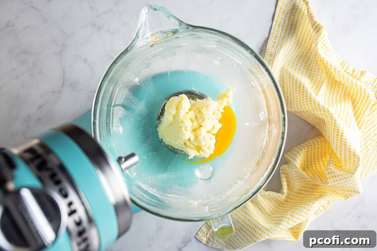 Creamed butter for ricotta cookies with eggs being added one at a time.