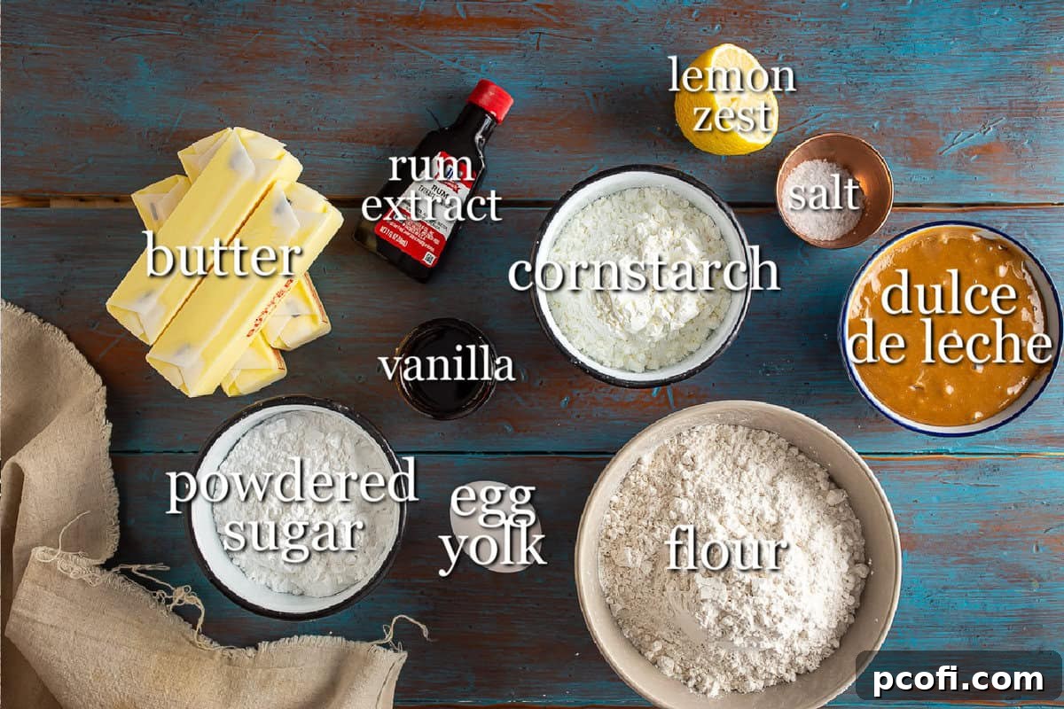 Various ingredients for Alfajores, including butter, powdered sugar, eggs, flour, cornstarch, and lemon, artfully arranged in individual containers on a rustic wooden background. This vibrant display emphasizes the freshness and quality of the components required for the recipe.