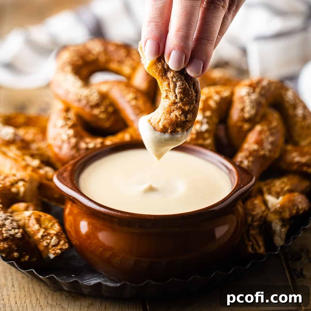 Dipping a homemade soft pretzel into beer cheese.