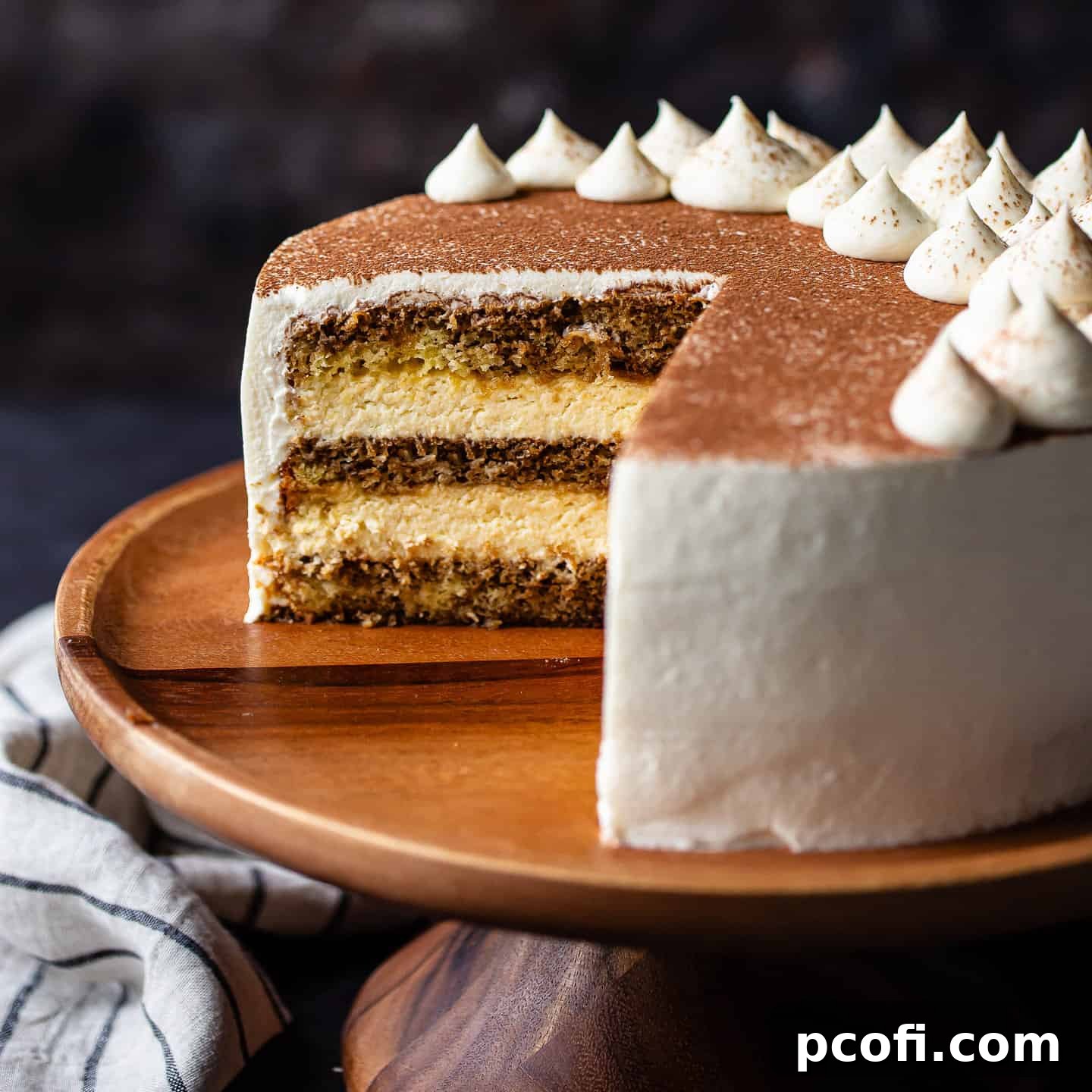 Tiramisu cake with a slice cut out, displaying the many layers.