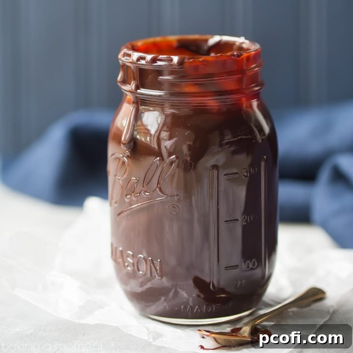 Thick, rich, and velvety hot fudge sauce in a glass serving bowl, ready for ice cream sundaes and dessert toppings.