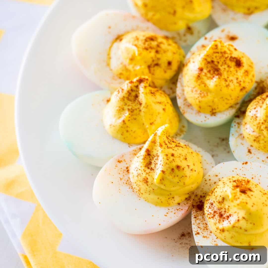 Classic deviled eggs arranged beautifully on a white plate with a yellow napkin.