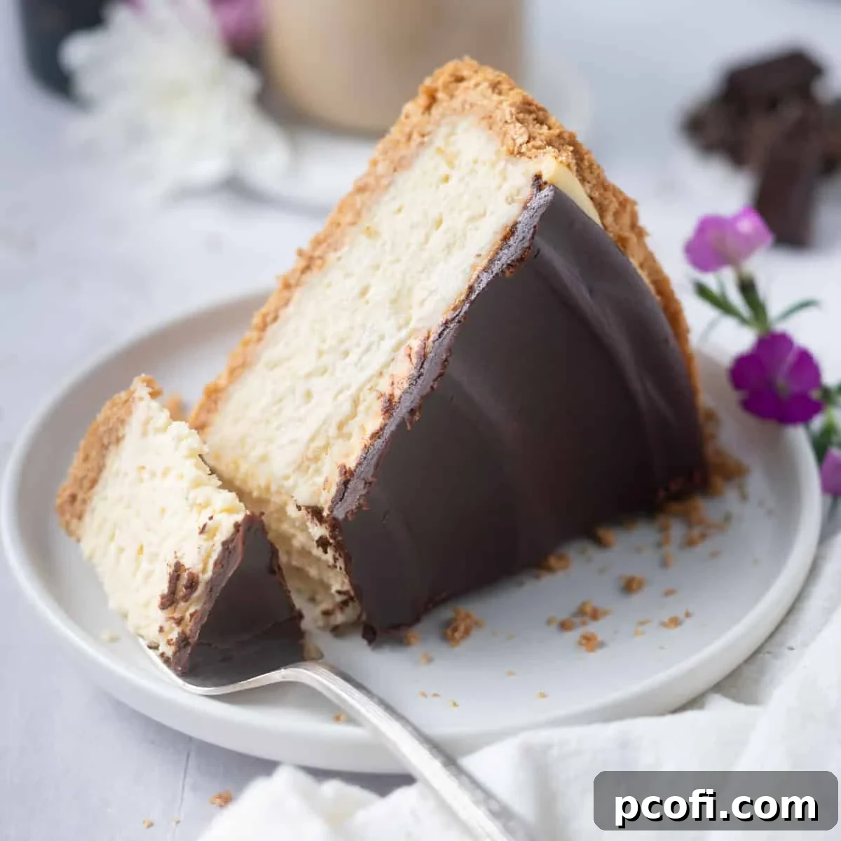 A delectable slice of Baileys Cheesecake on a plate, with a bite on a fork.