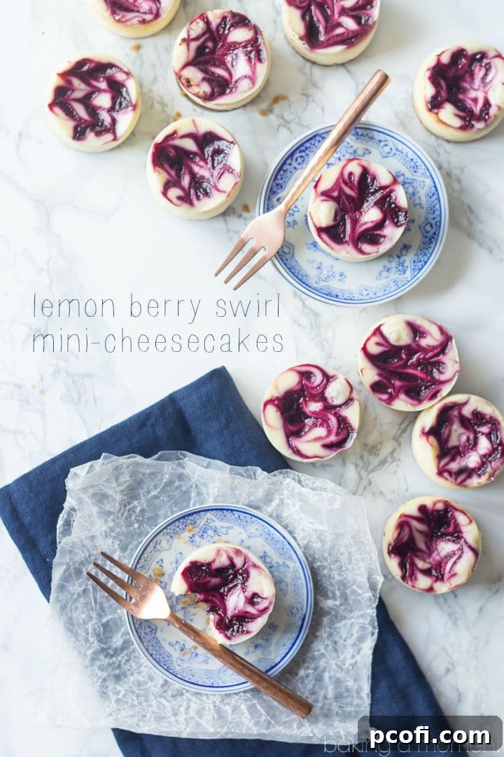 Close-up of Lemon Berry Swirl Mini Cheesecakes, showing the rich filling and colorful berry swirl, nestled in a mini-cheesecake pan.