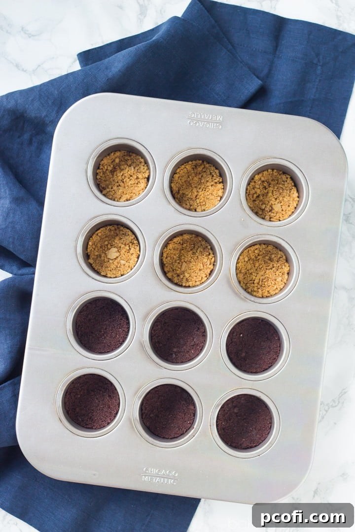 Various Lemon Berry Swirl Mini Cheesecakes, some with olive oil and sea salt cracker crust, others with double chocolate brownie thin crust.