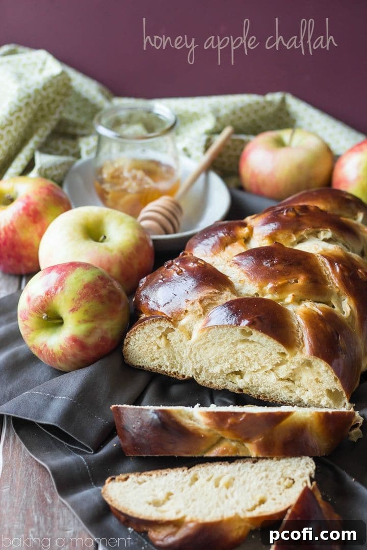 Close-up of a beautifully braided Honey Apple Challah, showcasing its golden crust and tender interior.