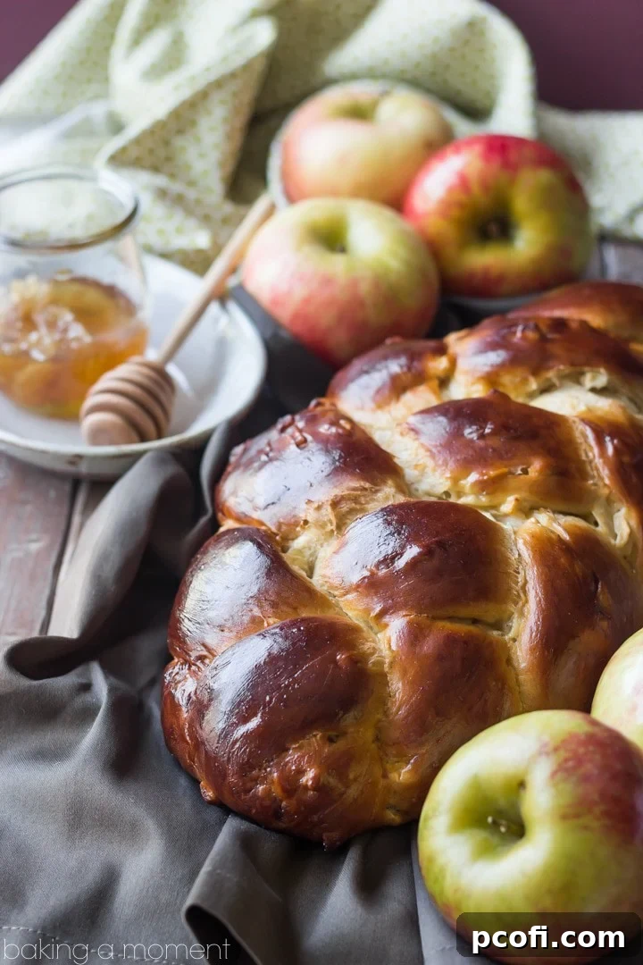 Freshly baked Honey Apple Challah loaf, ready to be sliced and enjoyed.