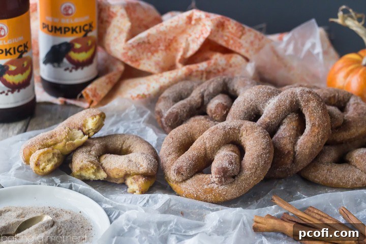 A basket full of freshly baked pumpkin beer soft pretzels, perfect for sharing. Their golden-brown crust and sugary coating are incredibly inviting.