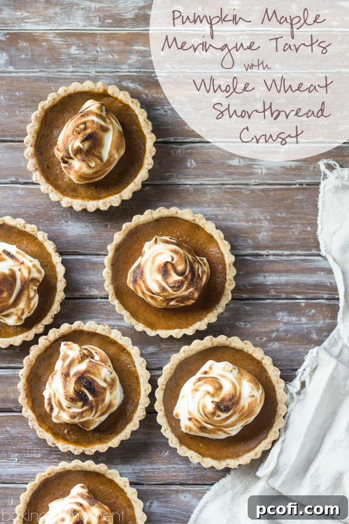 Close-up of a mini pumpkin meringue tart showcasing its creamy filling and perfectly browned meringue peaks.