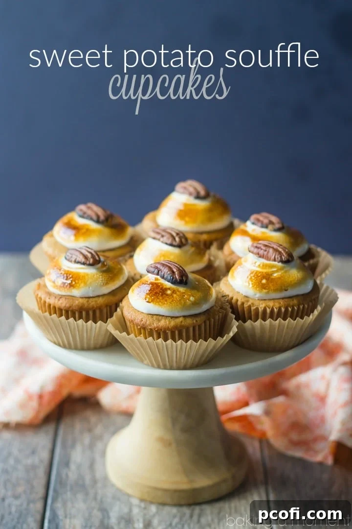 Close-up of Sweet Potato Souffle Cupcakes - highlighting the moist cake texture and the golden toasted marshmallow topping with a pecan.