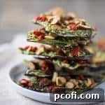 Dark Chocolate Almond Superfood Bark with matcha, goji berries, and chia seeds.