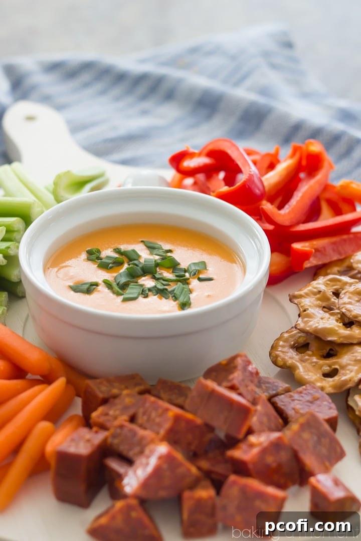 Delicious Cheddar-Blue Beer Cheese Dip garnished with fresh scallions, perfect party food
