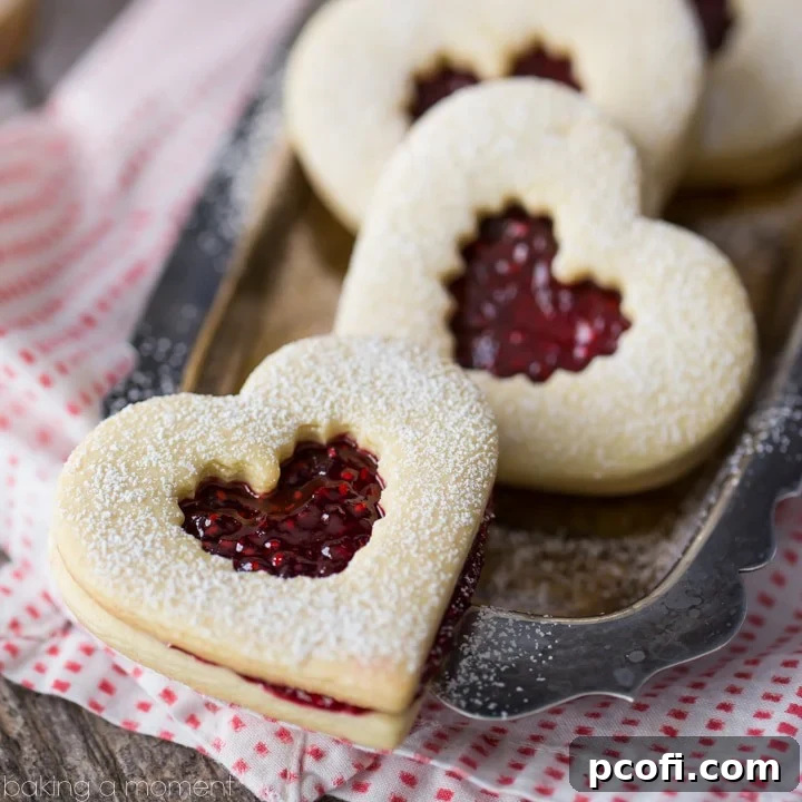 Classic Raspberry Linzer Cookies with a sweet homemade jam filling, perfect for holidays.