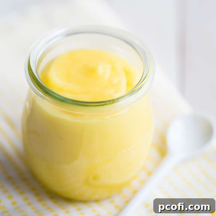 A jar of luscious lemon curd with a playful text overlay, 'This lemon curd was a cinch to make and the flavor was so bomb! I'll be giving little jars as gifts this Christmas ;)' emphasizing its ease and gifting potential.