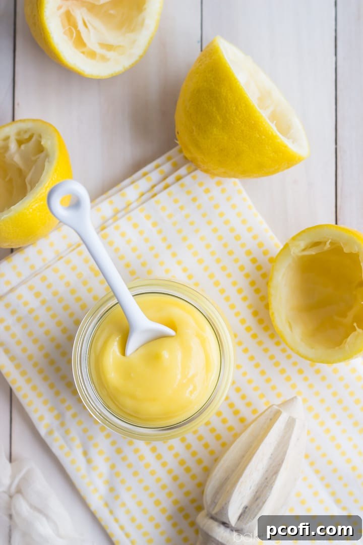 A jar of homemade lemon curd, shining with its vibrant yellow hue and smooth texture, ready to be served or gifted.