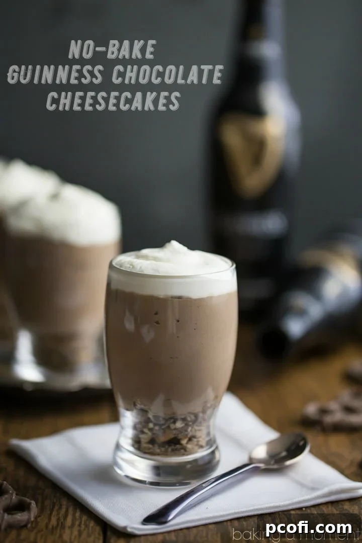 Multiple mini beer glasses of Guinness Chocolate Cheesecake Mousse, elegantly presented on a white napkin with spoons, with bottles of Guinness Stout in the soft-focus background. Highlighting the festive and individual servings.