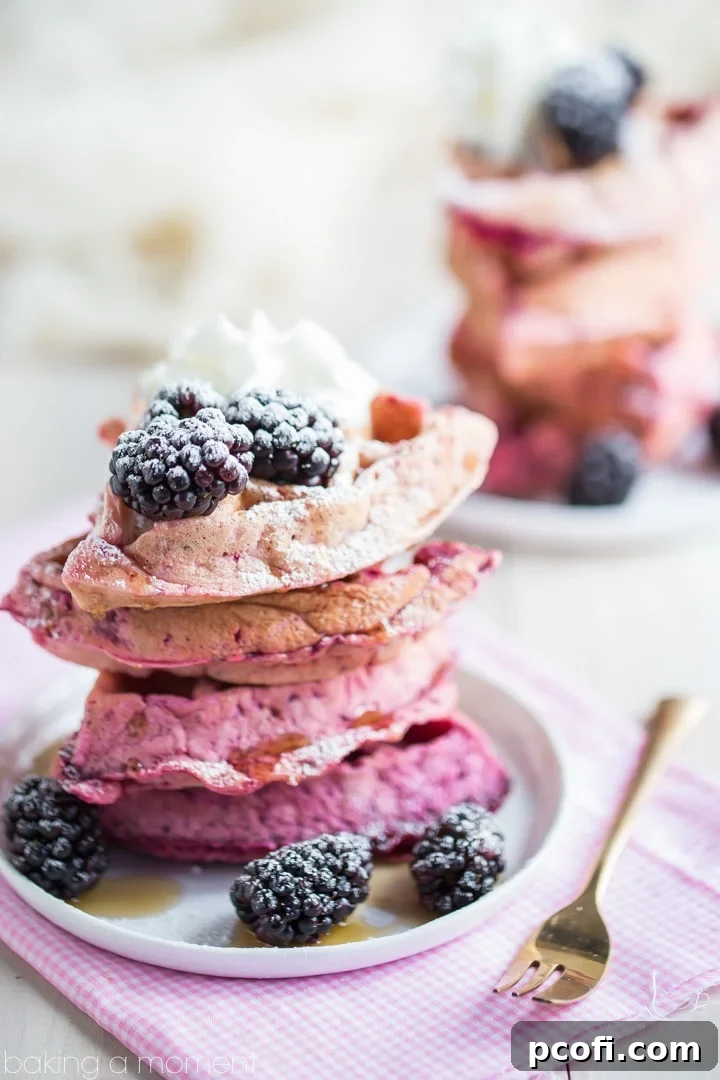 A stack of beautifully layered ombre waffles, showcasing the gradual color change.