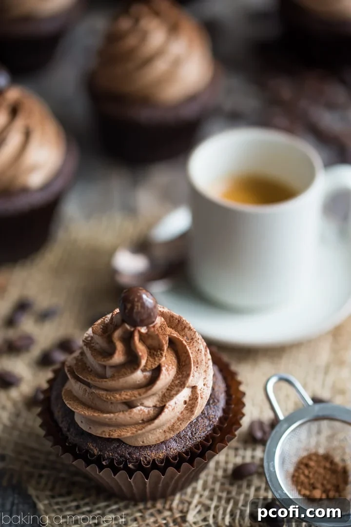 Three mocha cupcakes showcasing the elegant piping of the espresso buttercream.